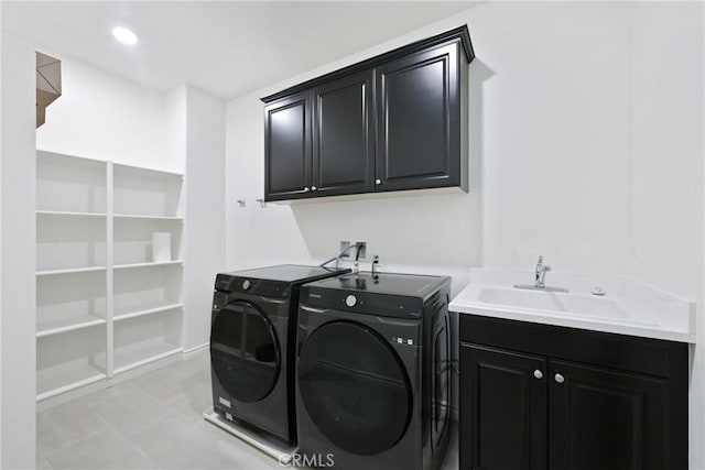 laundry room featuring cabinets, washing machine and dryer, and sink