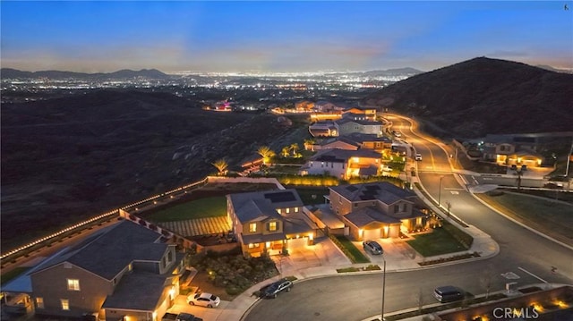 aerial view at dusk featuring a mountain view