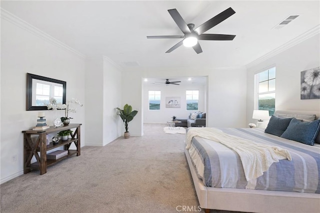 carpeted bedroom with multiple windows, ornamental molding, and ceiling fan