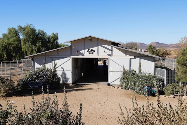 exterior space featuring an outbuilding, an exterior structure, and a mountain view