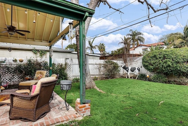 view of yard with a fenced backyard, ceiling fan, and a patio