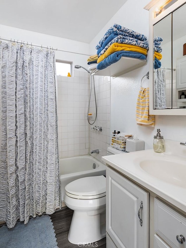 full bath with shower / tub combo, vanity, toilet, and wood finished floors