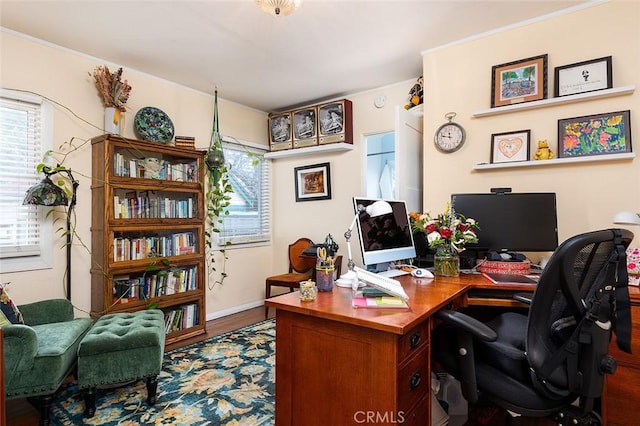 office area with plenty of natural light and wood finished floors