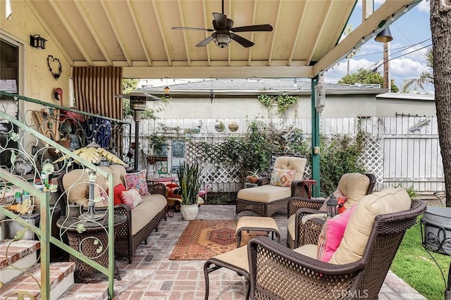 view of patio / terrace with fence, an outdoor hangout area, and a ceiling fan