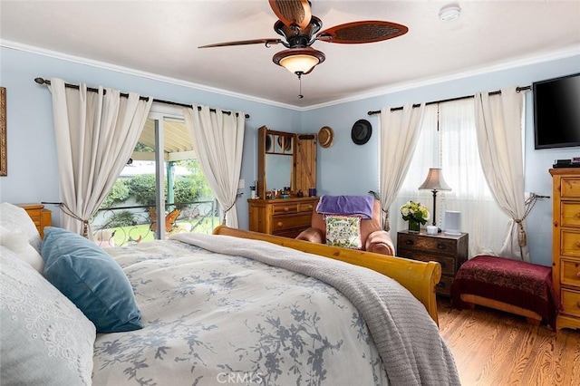 bedroom featuring access to exterior, a ceiling fan, wood finished floors, and ornamental molding