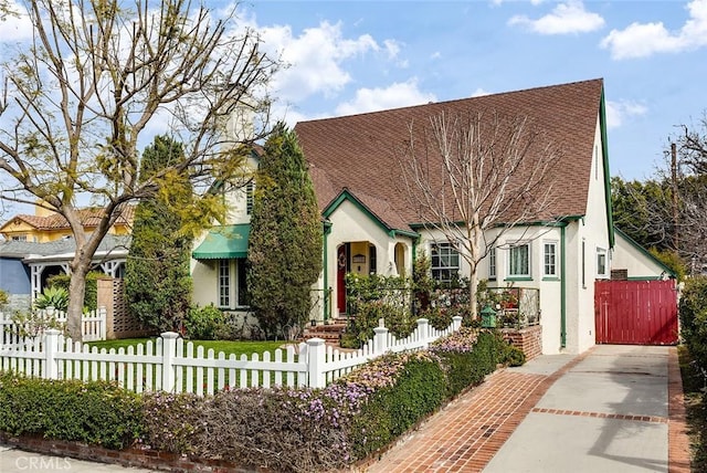 view of front facade with a fenced front yard and stucco siding