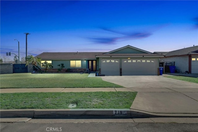 ranch-style house with a garage, a front yard, concrete driveway, and fence