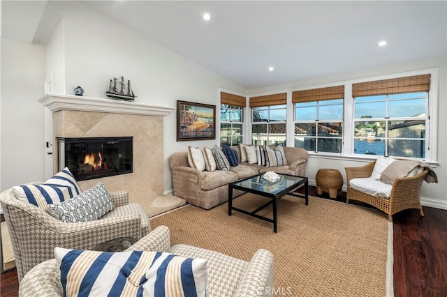 living room with lofted ceiling, wood-type flooring, and a premium fireplace