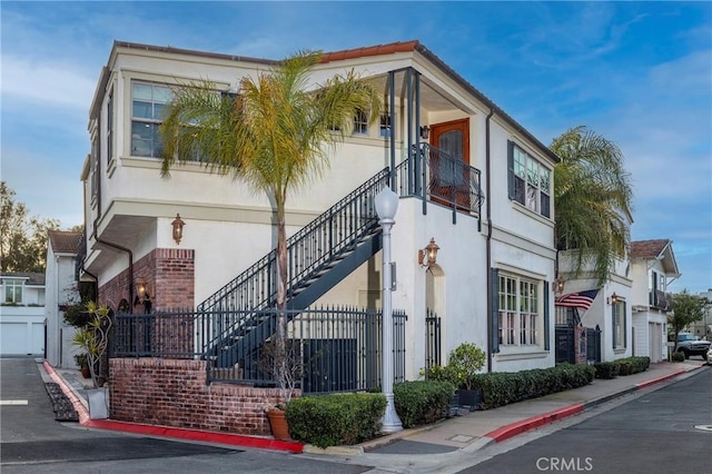 111 Via Lido Nord Unit B, Newport Beach, CA 92663 - view of front of home with stucco siding, stairway, and brick siding