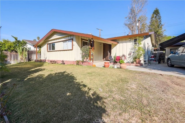 view of front of home with a patio and a front yard