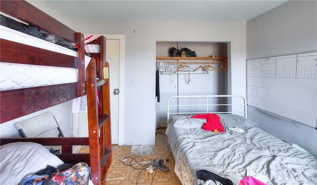 bedroom featuring parquet flooring and a mail area