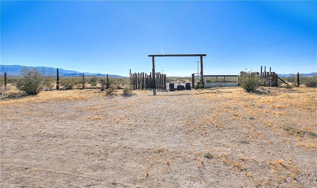 view of yard with a mountain view and a rural view