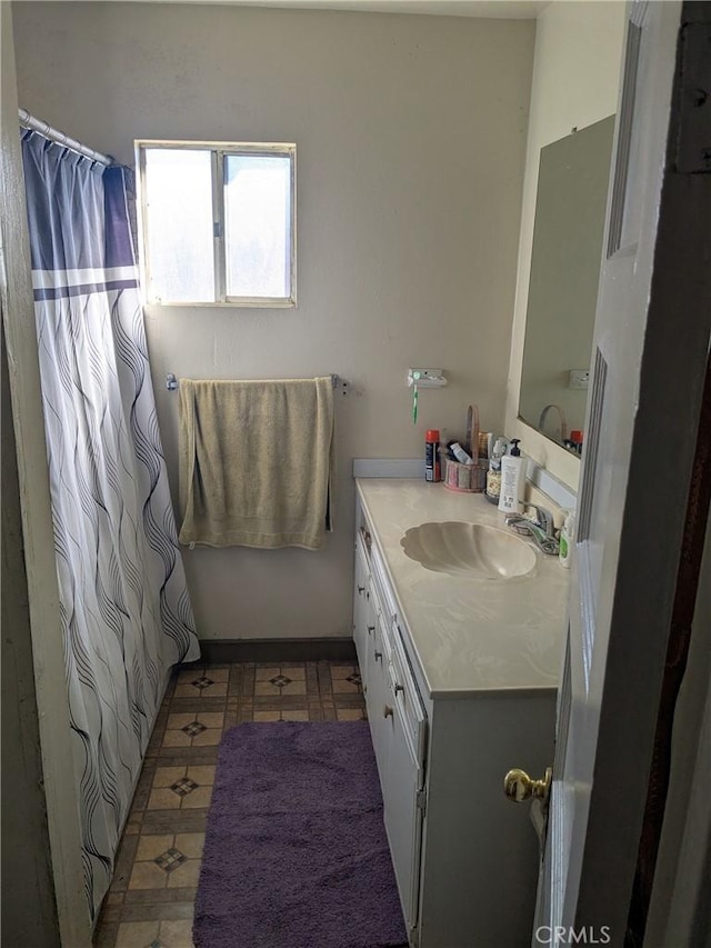 bathroom with vanity, a shower with shower curtain, and tile patterned floors