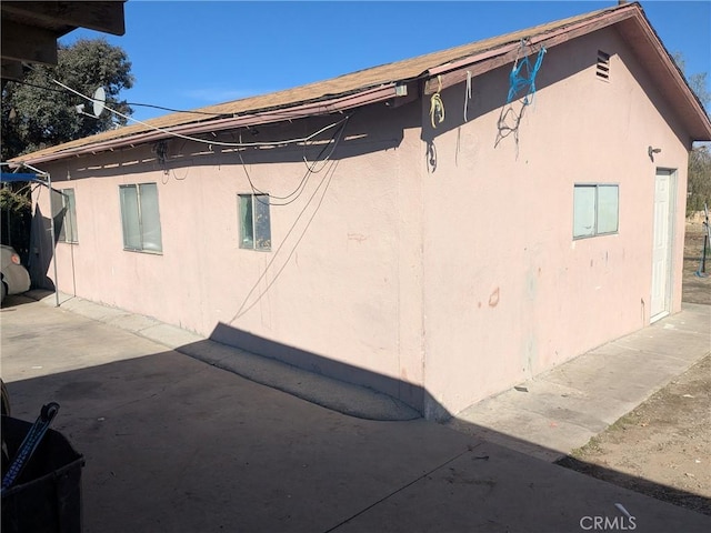 view of side of home featuring stucco siding