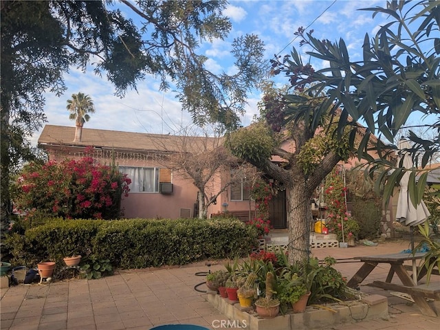 exterior space with a patio area and stucco siding
