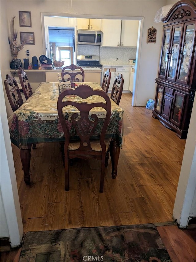 dining area with light wood-style floors