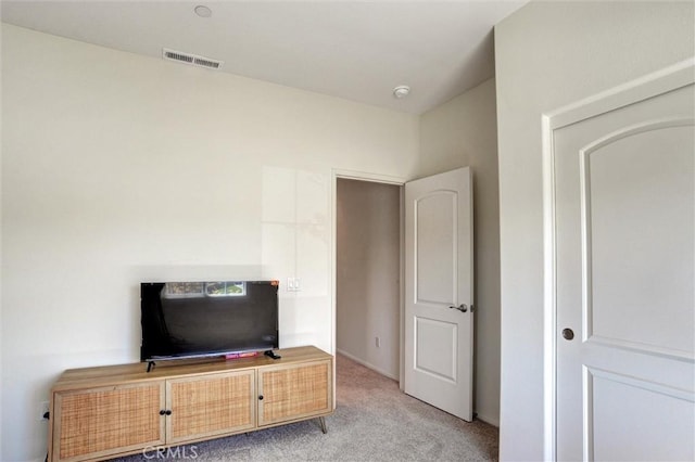 unfurnished bedroom with light colored carpet and visible vents