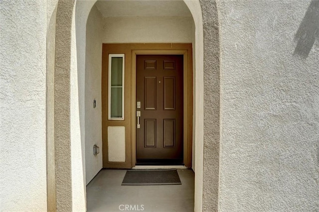 property entrance with stucco siding