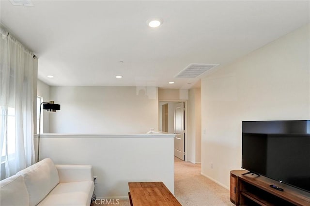 living area with visible vents, recessed lighting, baseboards, and light carpet