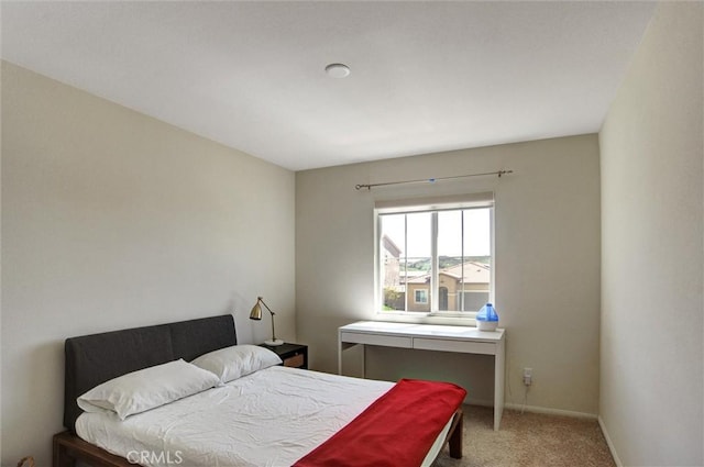 bedroom with baseboards and carpet flooring