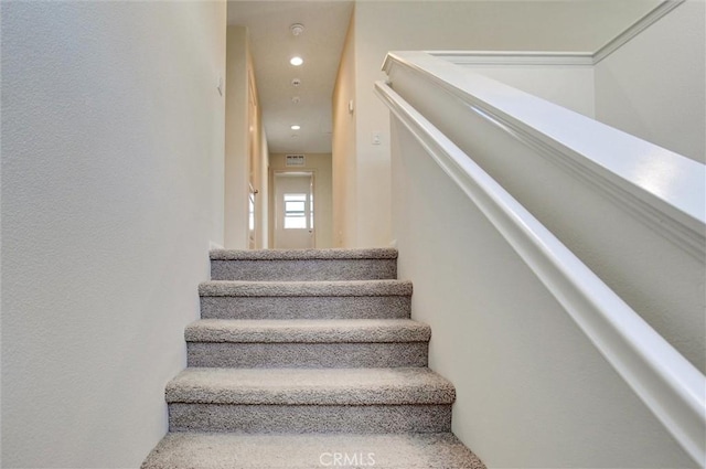 staircase featuring recessed lighting