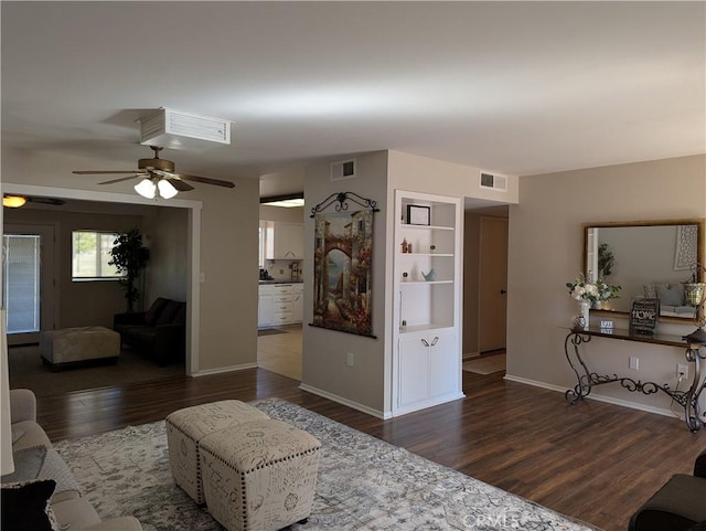 living room featuring dark hardwood / wood-style floors and ceiling fan