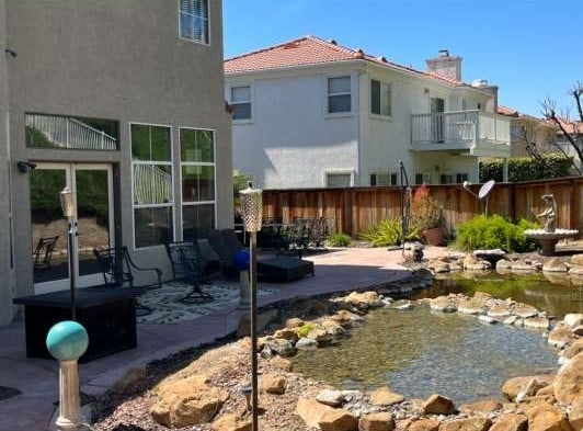 back of property featuring a patio area, fence, french doors, and stucco siding