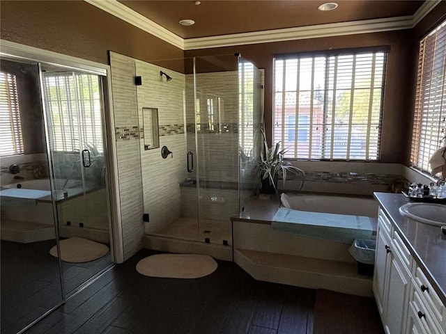 full bath with a wealth of natural light, crown molding, vanity, and hardwood / wood-style floors