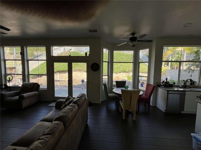 interior space featuring a ceiling fan, french doors, visible vents, and a sink