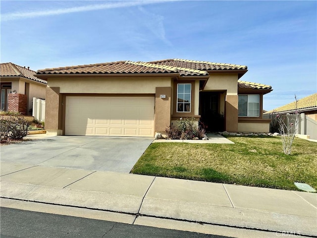 view of front of home featuring concrete driveway, a tile roof, an attached garage, a front lawn, and stucco siding