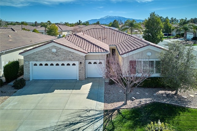 view of front of home with a mountain view and a garage