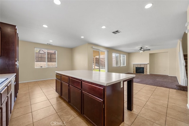 kitchen with plenty of natural light, a fireplace, visible vents, and light countertops