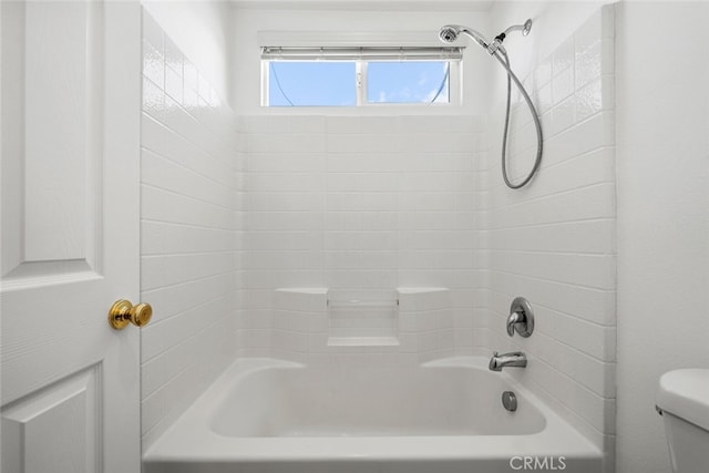 bathroom featuring shower / bathing tub combination and toilet