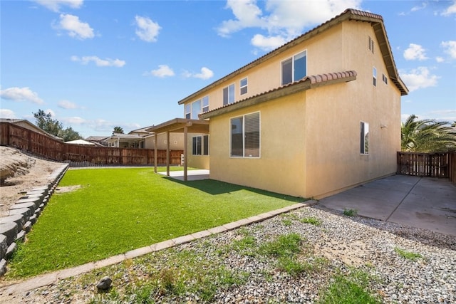 back of house with a lawn, a patio, fence, and stucco siding