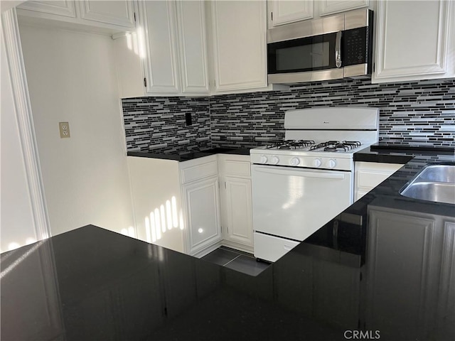 7422UNIT7 Hazeltine Ave Unit 7, Van Nuys, CA 91405 - kitchen with stainless steel microwave, gas range gas stove, tasteful backsplash, and white cabinets