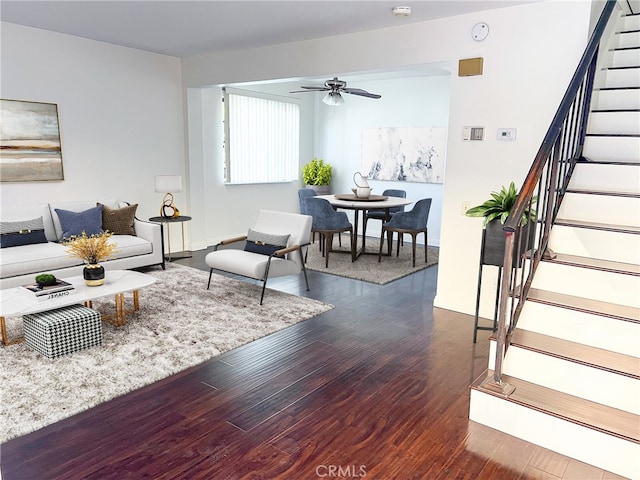 living room with ceiling fan and dark hardwood / wood-style flooring