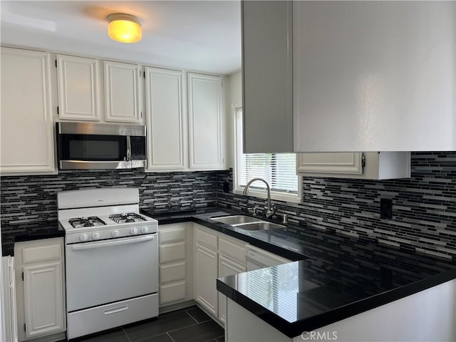 7422UNIT7 Hazeltine Ave Unit 7, Van Nuys, CA 91405 - kitchen featuring white appliances, a sink, dark countertops, and white cabinetry