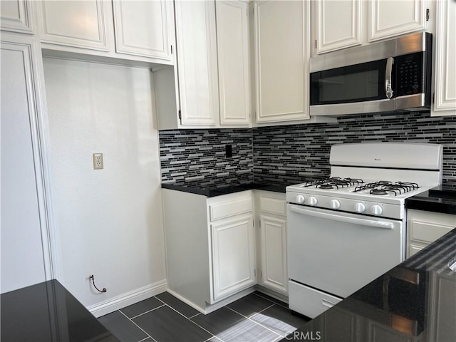 7422UNIT7 Hazeltine Ave Unit 7, Van Nuys, CA 91405 - kitchen featuring stainless steel microwave, white gas range, dark countertops, decorative backsplash, and white cabinets
