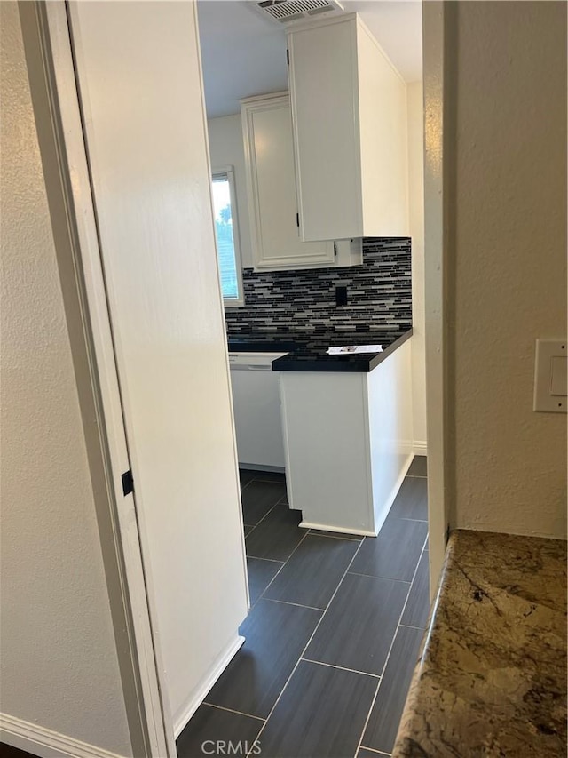 7422UNIT7 Hazeltine Ave Unit 7, Van Nuys, CA 91405 - kitchen featuring backsplash, white dishwasher, white cabinetry, and dark countertops