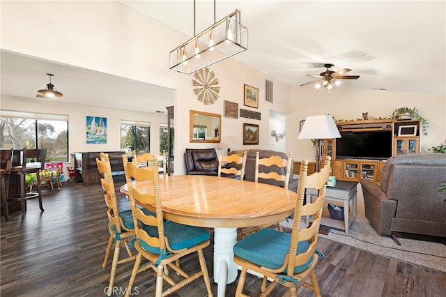 dining space with ceiling fan and dark wood-type flooring