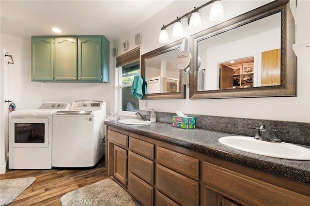 bathroom featuring hardwood / wood-style floors, vanity, and washing machine and clothes dryer