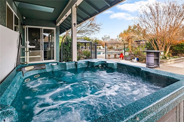 view of swimming pool featuring a hot tub