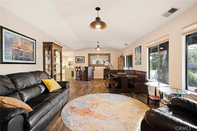 living room with dark hardwood / wood-style flooring and lofted ceiling