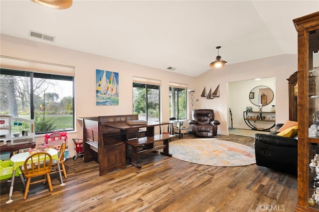 living room featuring vaulted ceiling and hardwood / wood-style floors