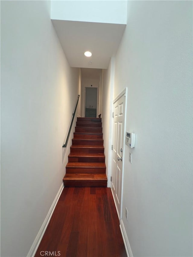 hallway with dark hardwood / wood-style floors