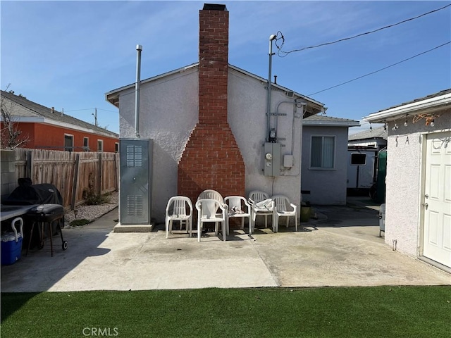 1408 S Burris Ave, Compton, CA 90221 - back of property featuring a patio, stucco siding, and a chimney