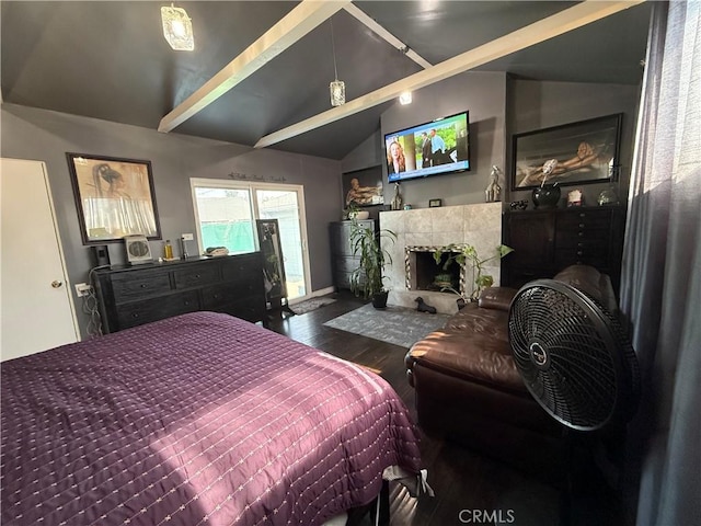 bedroom with vaulted ceiling with beams, hardwood / wood-style flooring, and a tile fireplace