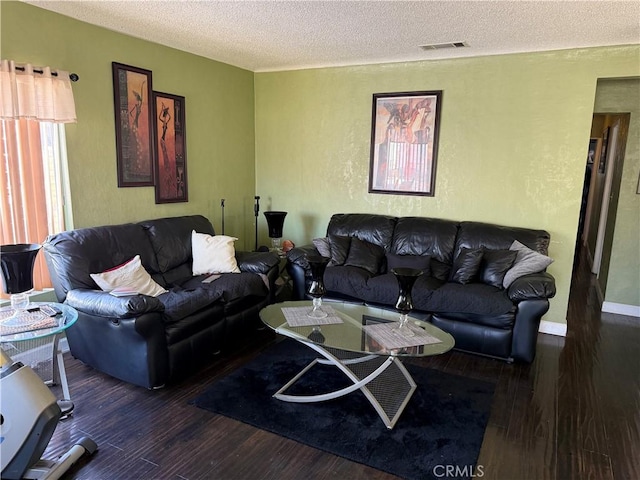 living room featuring dark hardwood / wood-style floors and a textured ceiling