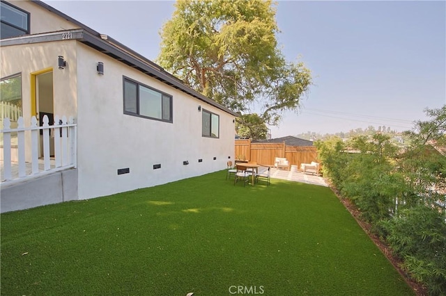 rear view of house featuring a yard and a patio area