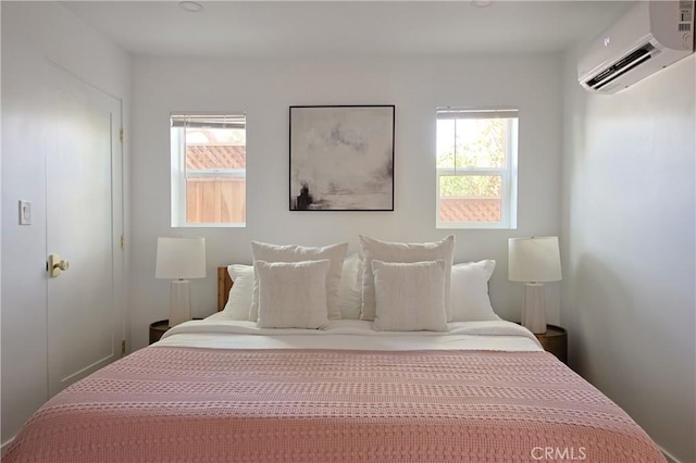 bedroom with an AC wall unit